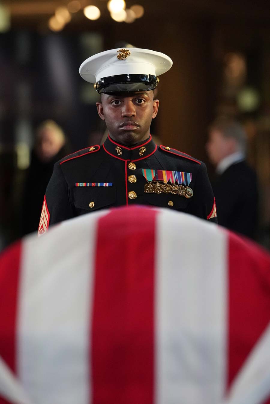 Sgt. Nayya Dobson-EL stands over the casket.